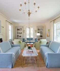 a living room filled with furniture and a chandelier