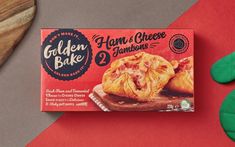 a box of golden bake ham and cheese turnovers next to a pair of green oven mitts