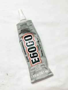 a tube of eco toothpaste sitting on top of a white sheeted surface