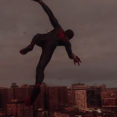 a man flying through the air while riding a skateboard in front of a city