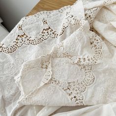 white lace is laying on top of a bed