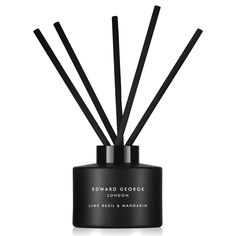 reed diffuser with black sticks in front of it and the words edward george on top