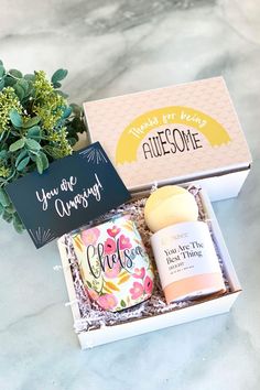 the gift box contains two mugs, a note card and a potted plant