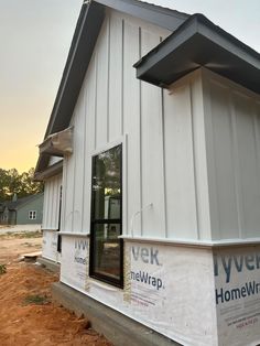 the side of a house being built with new windows and sidings on it's sides