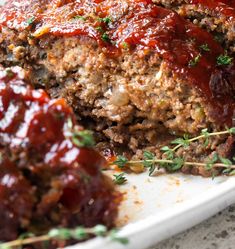 meatloaf with sauce and herbs on a plate