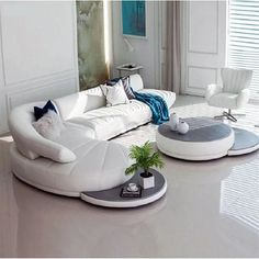 a modern living room with white furniture and blue accents