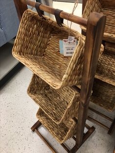 two wicker chairs with tags on them sitting in a store display area next to each other