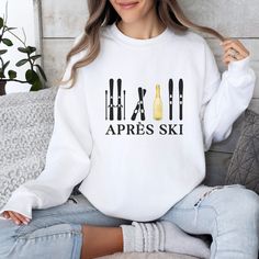 Step out of the ski slopes and into style with this cozy and cute Apres Ski sweater. Featuring an apres ski design, this comfortable skiing sweater is perfect for those chilly days. The colors and unique pattern give this sweater a retro feel. Whether you're lounging around the cabin or hitting the town with your friends, this Apres Ski sweatshirt will keep you warm and looking your best. Information - Gildan 18000 Unisex Sweatshirt - 50% Cotton 50% Polyester - Ribbed knit collar - Printed with the highest quality and durability Care Instructions - Machine wash: warm (max 40C or 105F) - Non-chlorine bleach - Tumble dry on low or lay flat to dry - Do not iron directly into design - Do not dryclean Sizing - Sizes are unisex - It fits true to size, or size up for an oversized fit. - Please re Winter Sports Sweatshirt, Sporty Sweatshirt For Winter Sports, Casual Crew Neck Sweater For Ski Season, Casual Tops For Winter Sports, White Long Sleeve Sweatshirt For Winter Sports, Casual White Sweatshirt For Winter Sports, Sporty Crew Neck Top For Ski Season, White Crew Neck Sweatshirt For Winter Sports, Casual Winter Skiing Tops