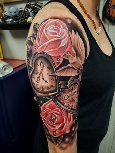 a woman with a clock and roses tattoo on her arm