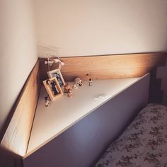 a bed with a wooden head board on top of it next to a framed photo