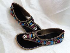 Casual, colourful shoes and sandals in leather from India: Fashion footwear for the contemporary city dweller, from five centuries back. Mumtaz, the lady for whom the Taj Mahal was built probably lived in shoes and sandals much like these. Originally meant for the Maharajahs and the Maharanis [Kings and Queens and such royalty], these handcrafted fashion footwear for men and women mainly come from the villages of Punjab and Rajasthan. This period fashion piece was introduced to India during the Bohemian Multicolor Embroidered Sandals, Traditional Blue Closed Toe Sandals, Round Toe Sandals For Party Festivals, Flat Sandals For Diwali, Festival Round Toe Sandals For Parties, Flat Sandals For Festive Diwali, Flat Sandals For Festive Diwali Celebrations, Festival Party Sandals With Round Toe, Festival Sandals With Cutdana And Round Toe