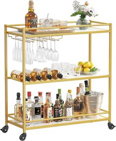 a gold bar cart filled with bottles and glasses