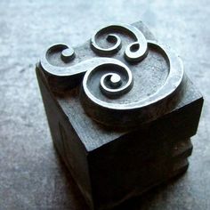 a wooden block with metal designs on it