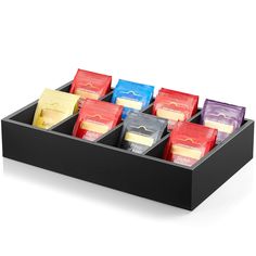 a black tray with six compartments filled with different types of candy bars on it's sides