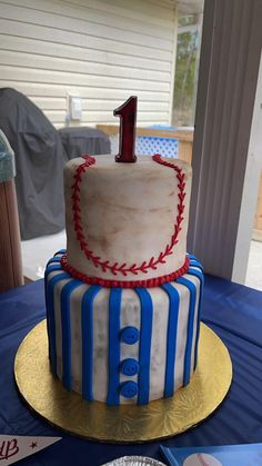 a baseball themed birthday cake with the number one on top