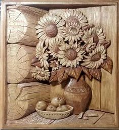 sunflowers and apples in a vase carved into wood