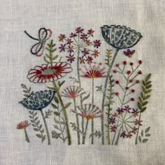 embroidered flowers and butterflies on white linen