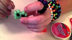 someone is making bracelets out of beads