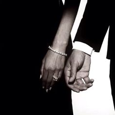 two people holding hands in black and white