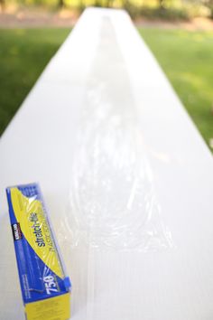 an empty white table with a tube of toothpaste on it