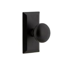 a black door handle with a round knob on an isolated white background for use in interior or exterior decor