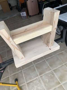 a wooden shelf sitting on top of a tile floor