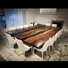 a dining room table with white chairs and a large wooden slab on the center piece