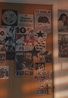 a wooden door covered in posters and stickers with the words tv girl on it