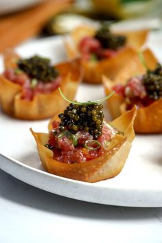 small appetizers are arranged on a white plate