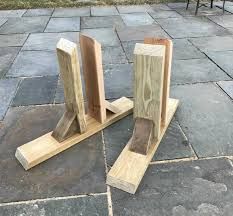 two pieces of wood sitting on top of a stone floor