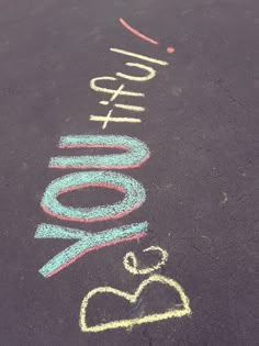 chalk writing on the pavement that says you got 100k written with colored pencils