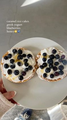 two blueberries are sitting on top of a white plate