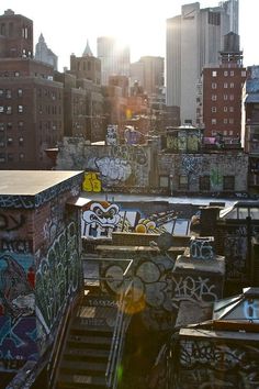 the sun shines brightly on graffiti covered buildings