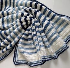 a crocheted dishcloth with blue and white stripes