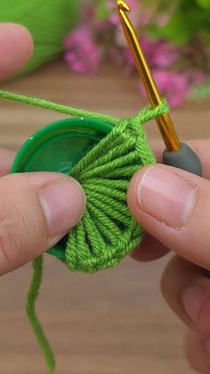 someone is crocheting the end of a green piece of yarn