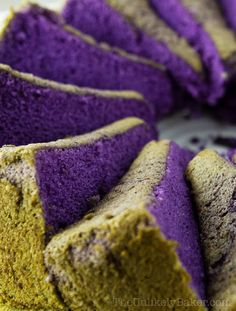 a cake with purple and yellow frosting on it's edges is sitting on a plate