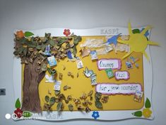 the bulletin board is decorated with paper and leaves