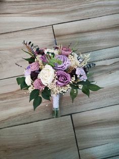 a bouquet of flowers sitting on top of a wooden floor