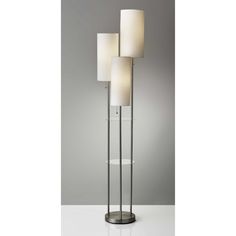 three lamps on a white table with grey background