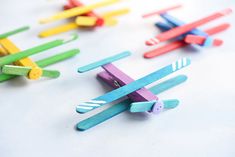 colorful popsicle airplanes are lined up on the table