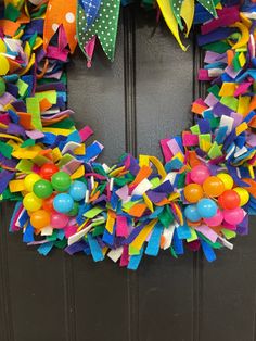 a colorful wreath is hanging on the front door