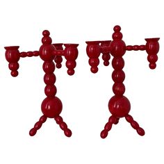 two red candlesticks sitting on top of each other