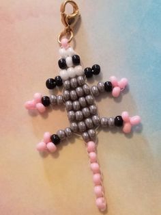 a keychain made out of beads with a cross on it