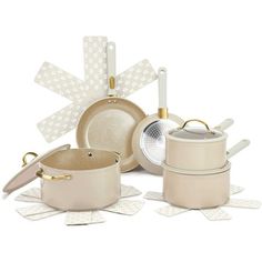 an assortment of pots and pans are shown on the white background, including one with gold handles