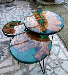 three tables sitting on top of each other in the middle of a sidewalk with an elephant painted on them