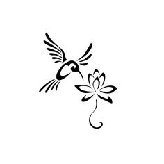 a black and white bird flying over a flower