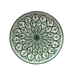 a green and white plate with an intricate design on the front, against a white background