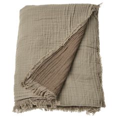 a blanket with fringes on top of it