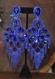 "These fun and stylish rhinestone extra long earrings are a great statement piece! You will stand out with these oversized wide royal blue earrings! Pageant, photo shoots or stage! Size of earrings: 2.5\" Wide and a stunning 6\" Long. Color: Royal Blue Base Metal: Silver Clip on available! Just select \"clip on\" under style Please note these earrings are oversized earrings. Clip on option available More colors available! Just send us a message! Looking for a matching bracelet? check out our bra Royal Blue Jewelry, Blue Diamond Earrings, Royal Blue Earrings, Extra Long Earrings, Pageant Earrings, Queen Jewelry, Oversized Earrings, Prom Earrings, Funky Earrings