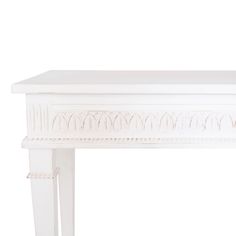 a white table with an ornate design on it's top and bottom shelf, against a white background